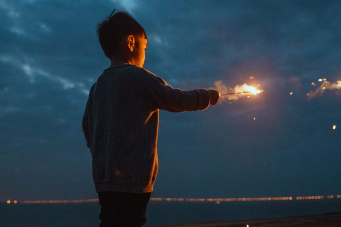 little boy holding sparkler