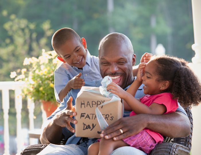 daughter and son giving their dad a father's day gift