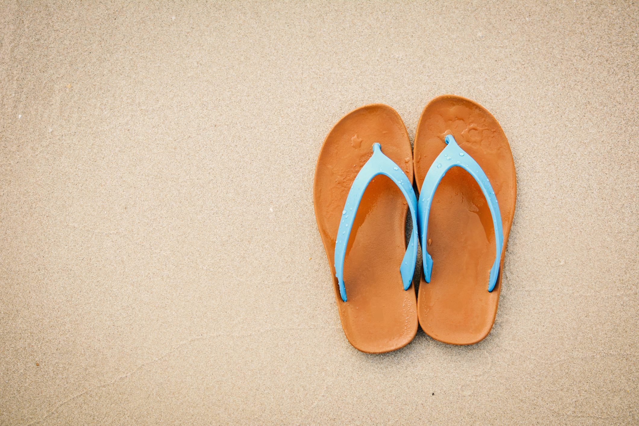 flip flops shot from above on sand beach