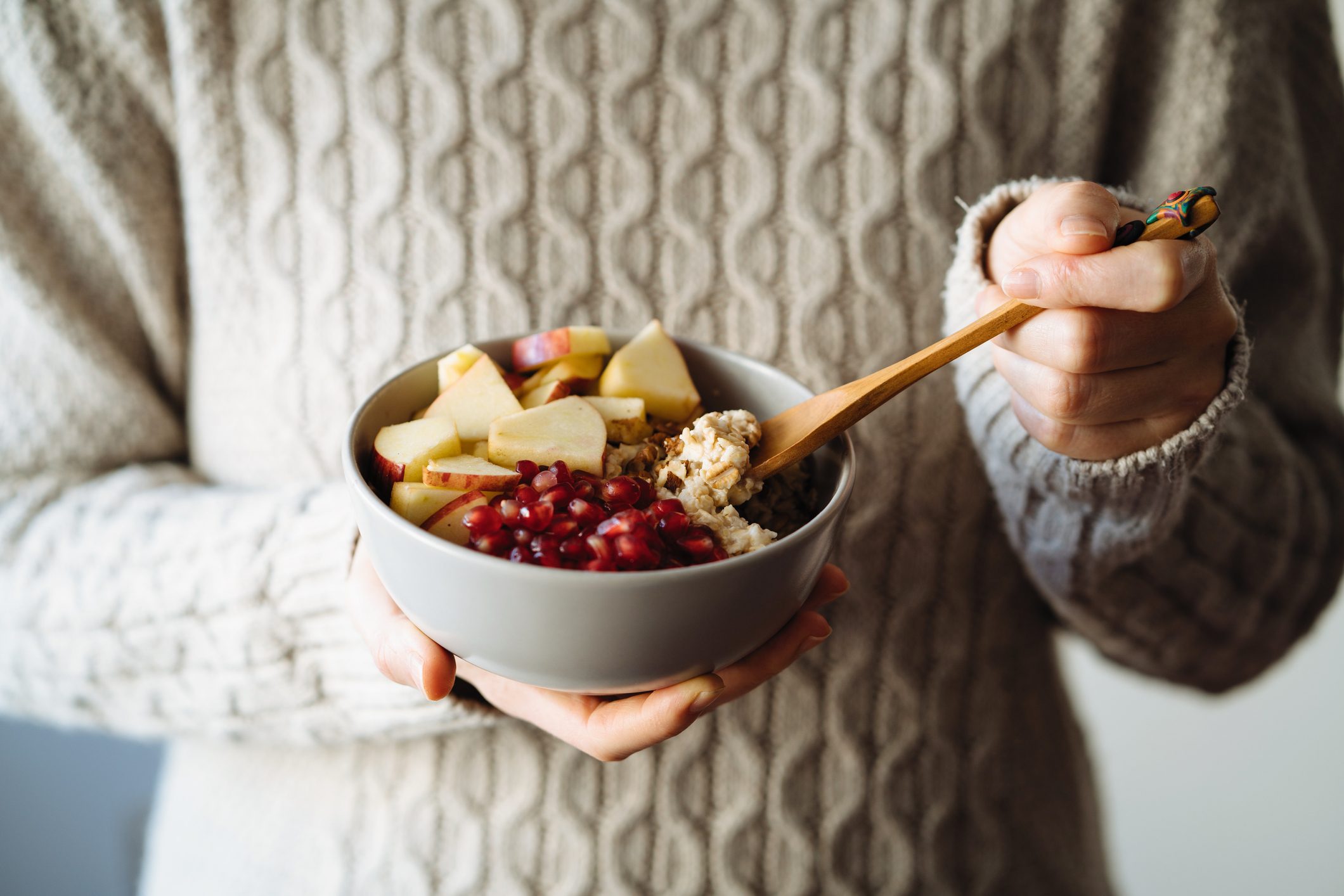 cropped shot of woman eating oatmeal