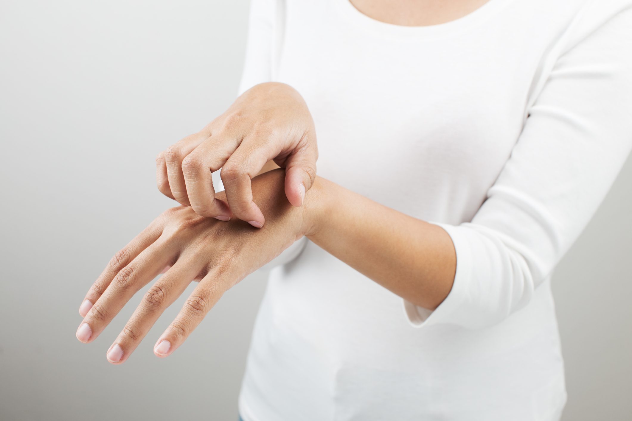 close up of woman scratching hand