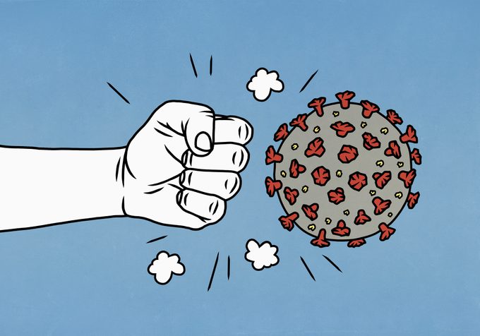 angry fist next to covid-19 virus illustration