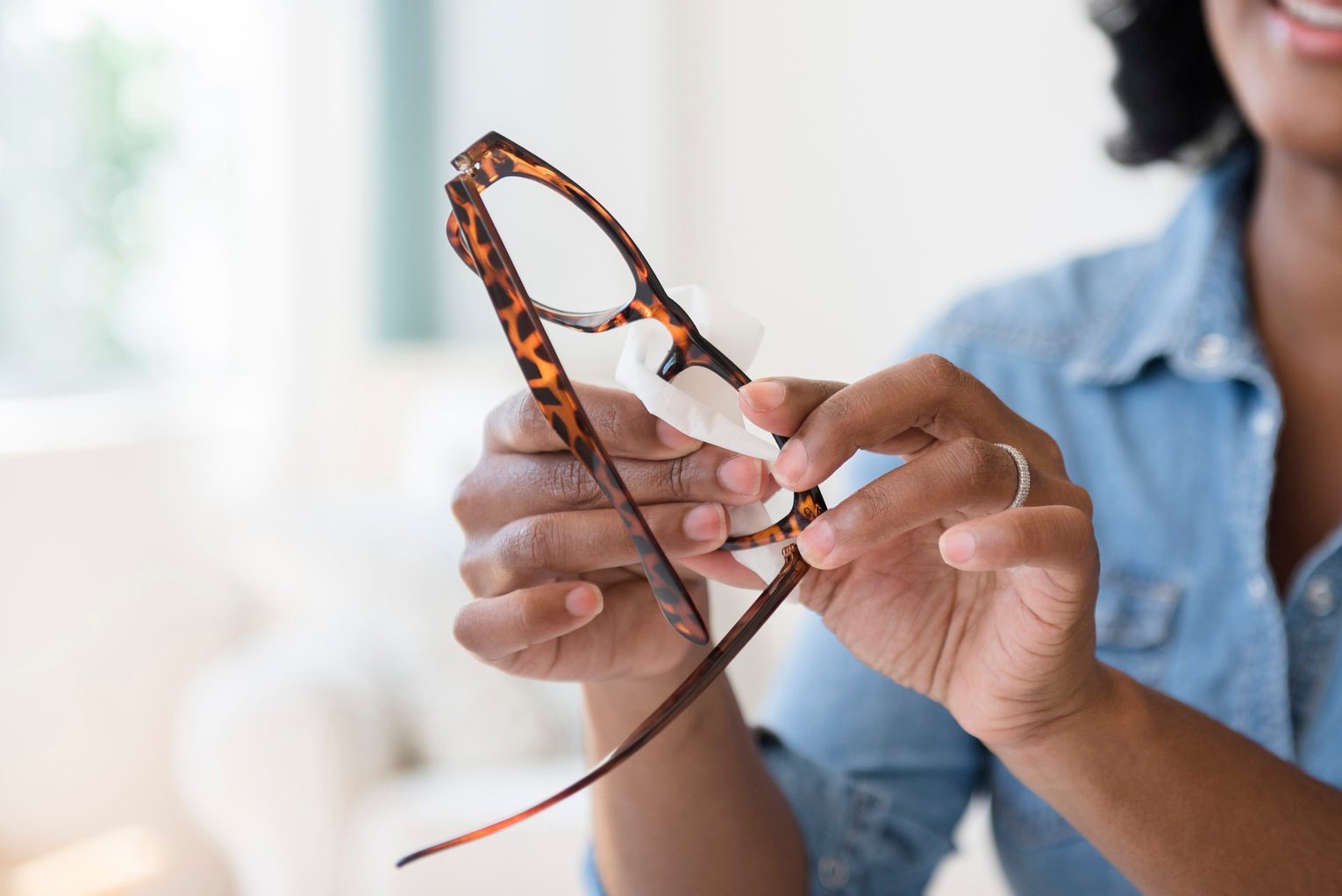 woman cleaning her eyeglasses