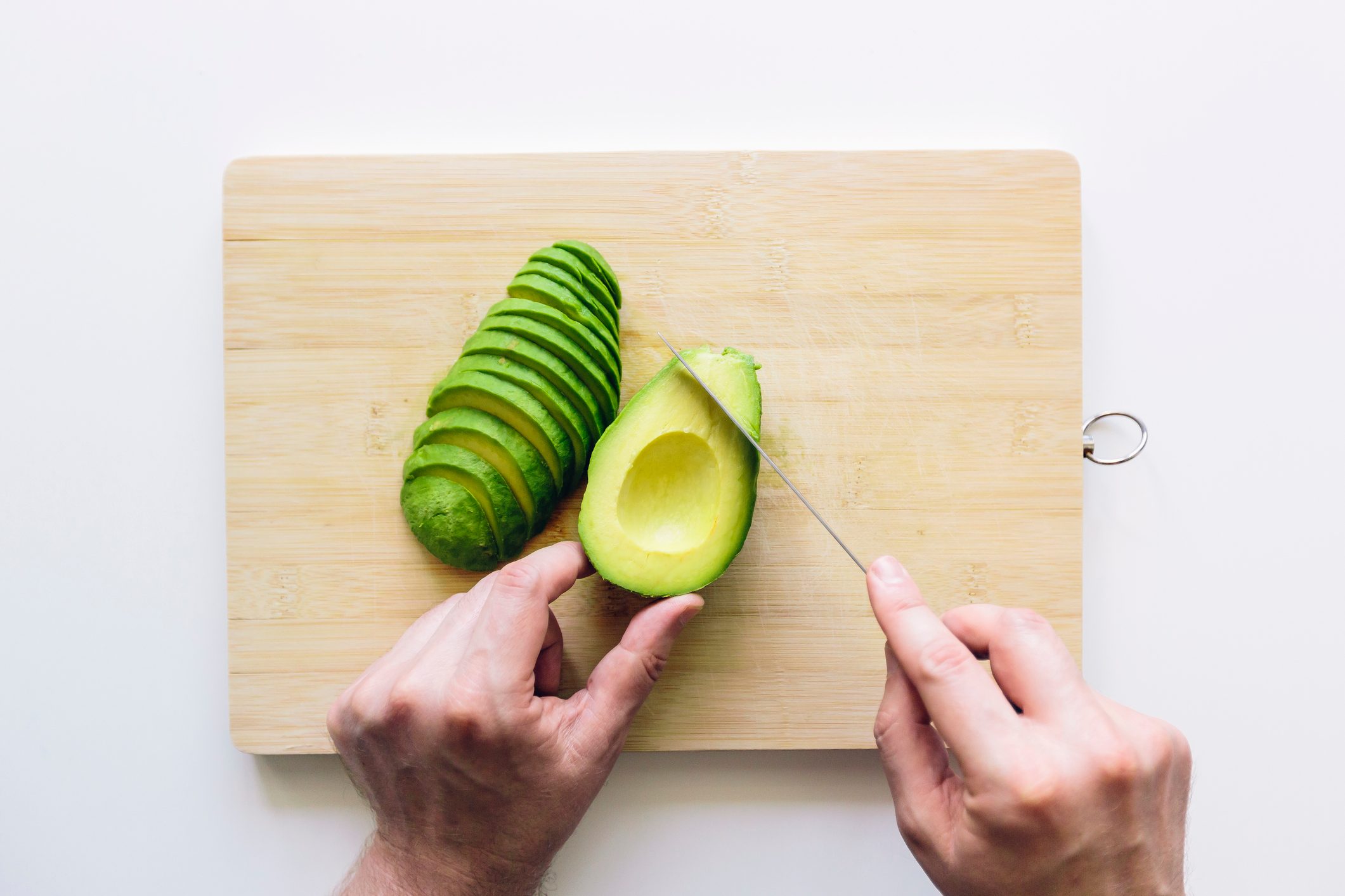 overhead shot of man slicing avocado