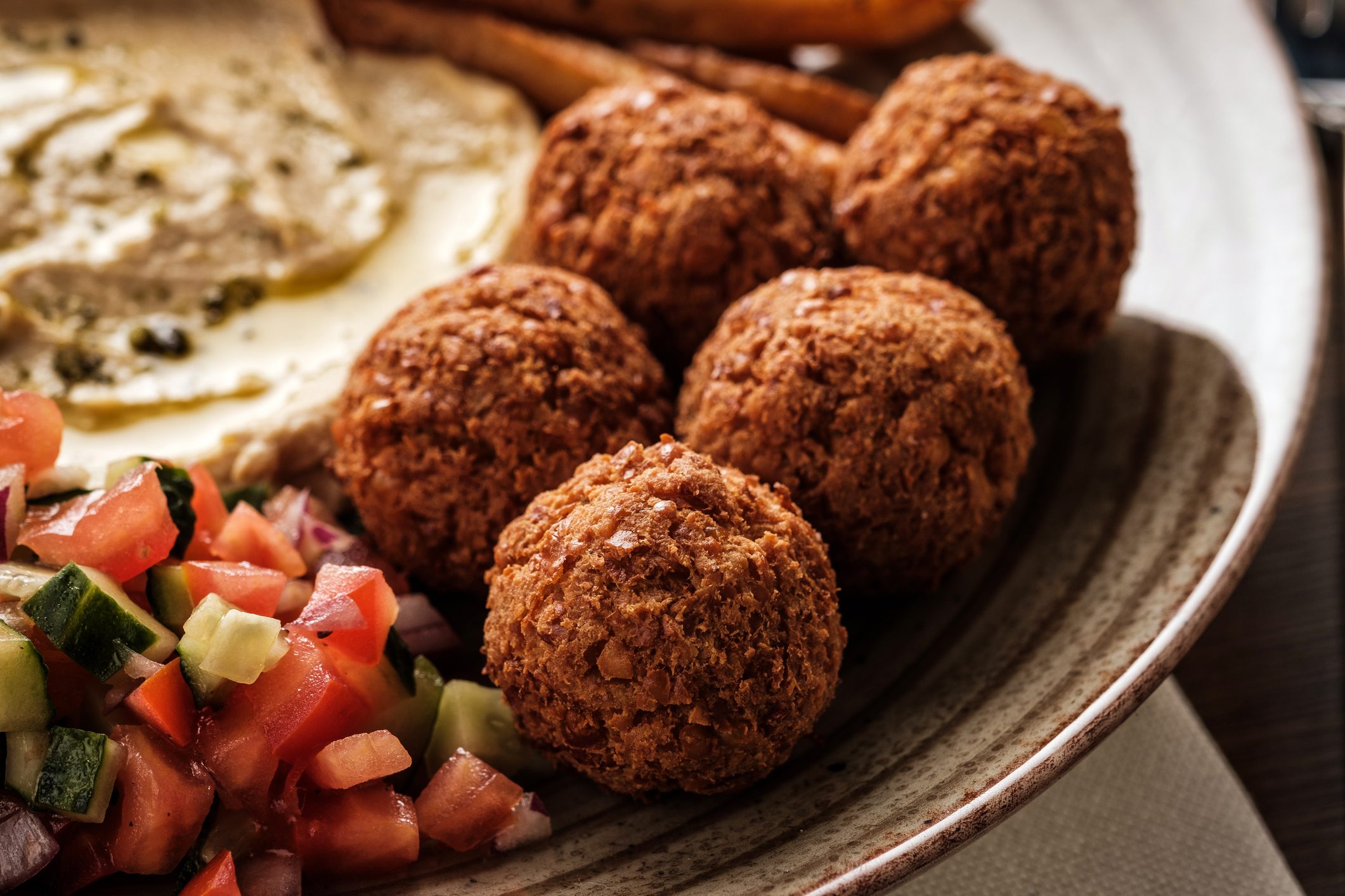 Close-up of Traditional falafel balls with salad and hummus on a plate