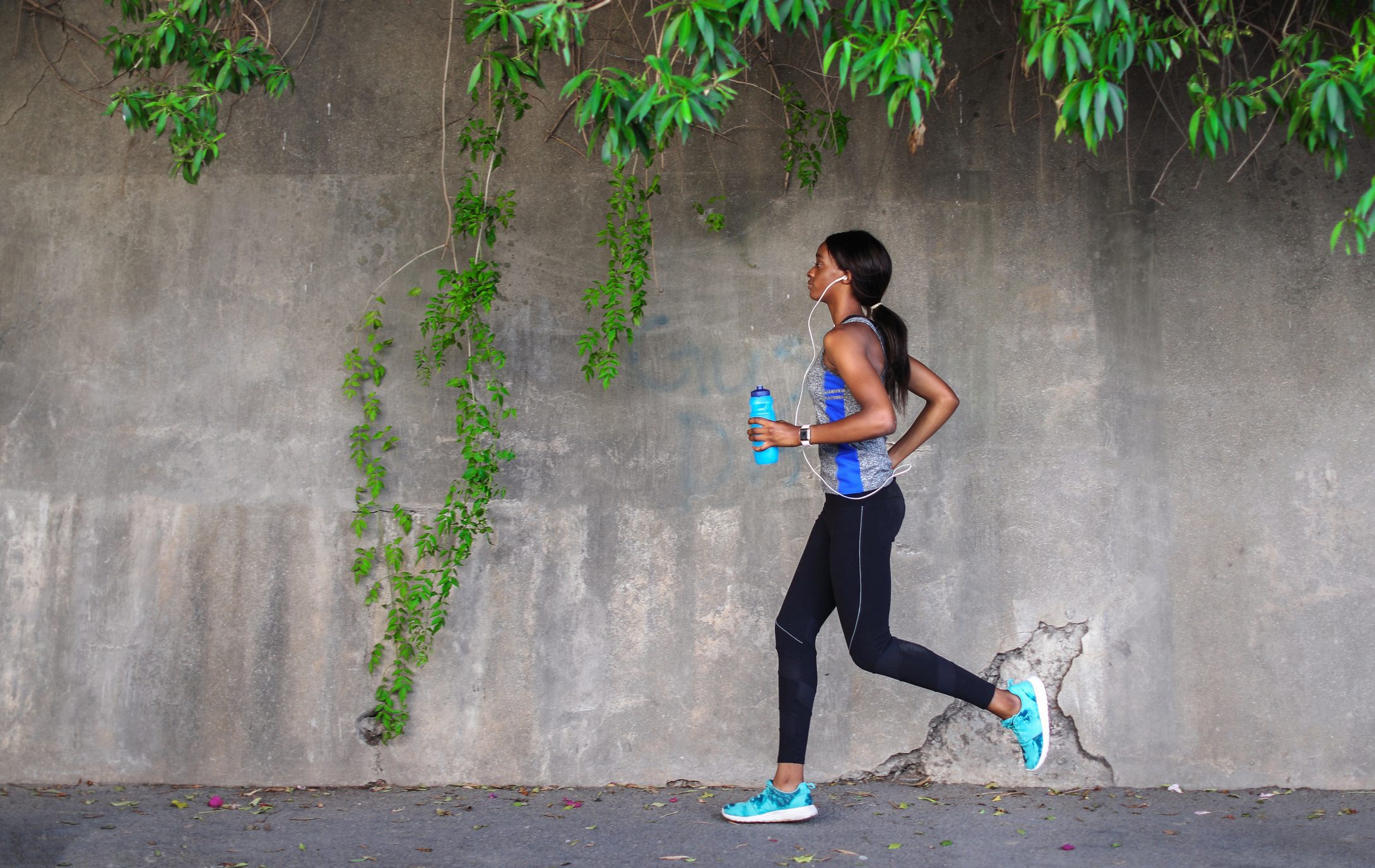 young female runner running outside