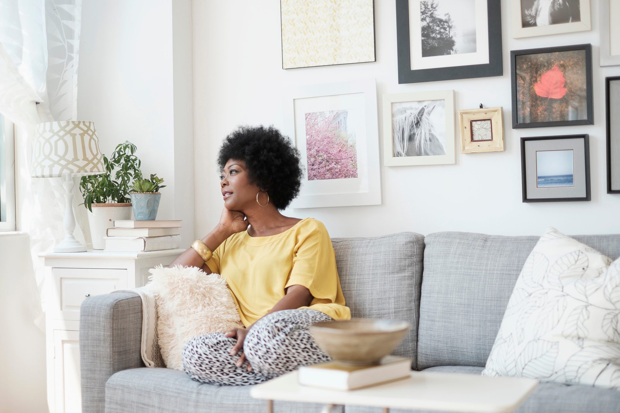 woman sitting at home and relaxing on couch