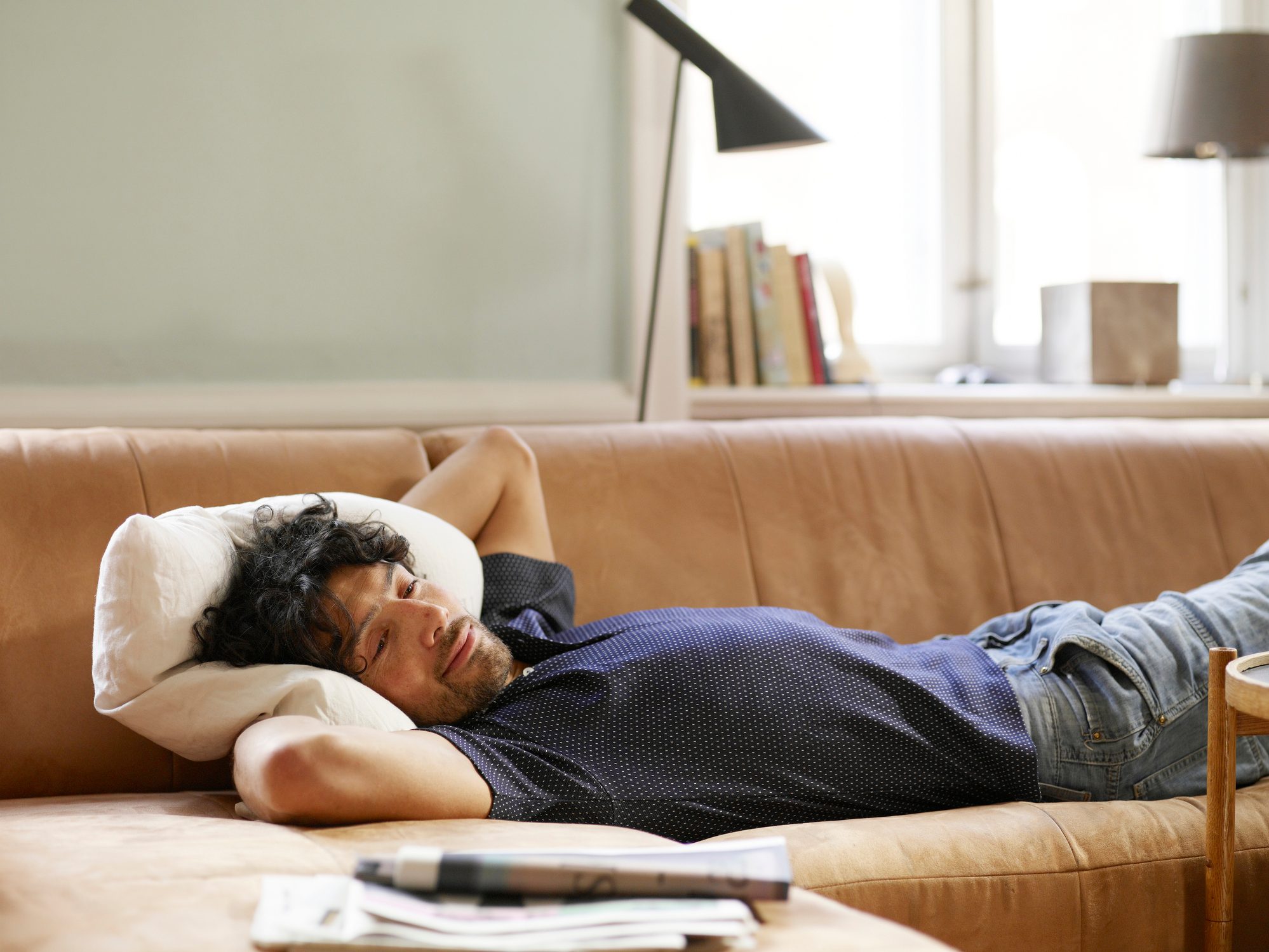man laying on couch at home