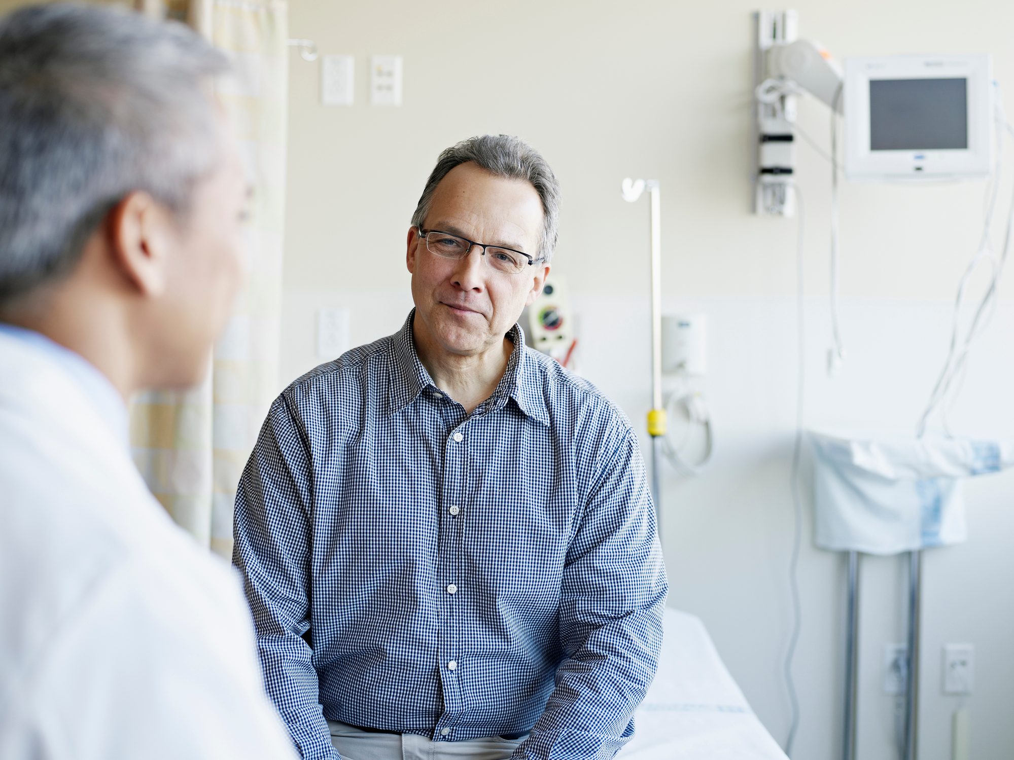 Doctor talking to patient in hospital room