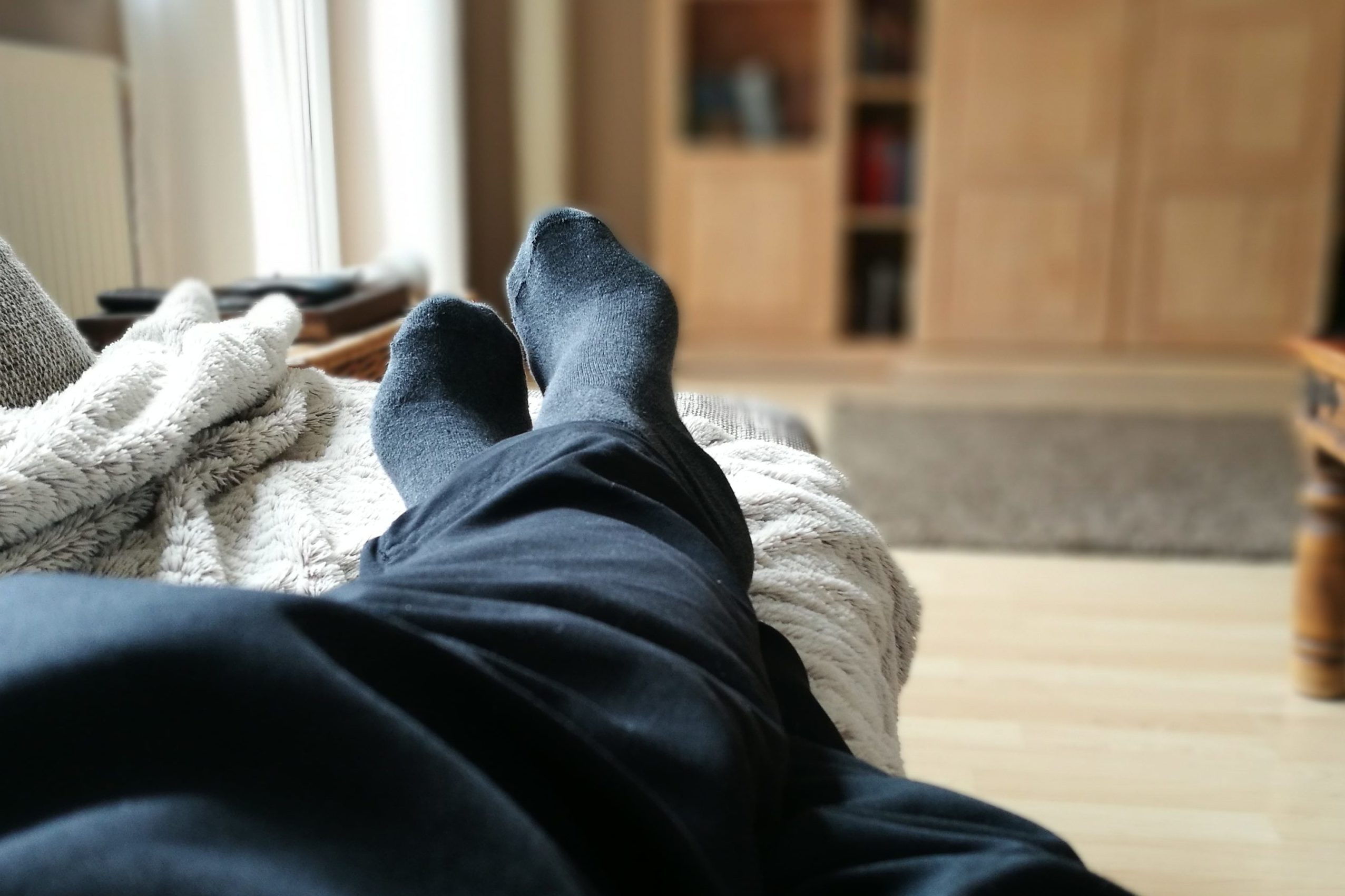 person resting on couch at home