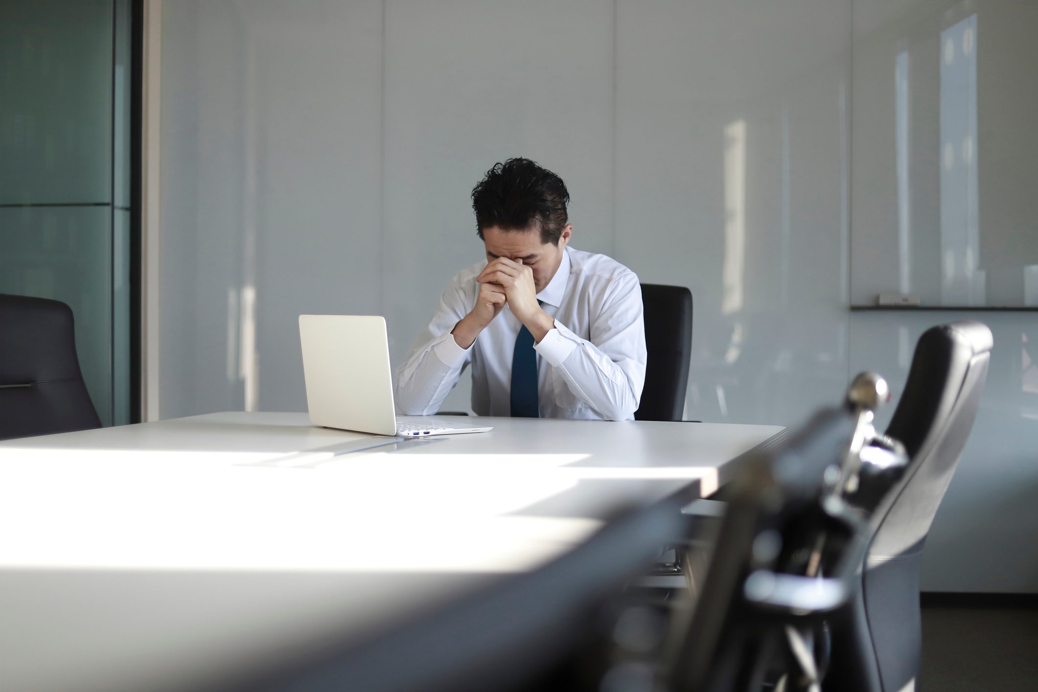 Stressed mature businessman with laptop