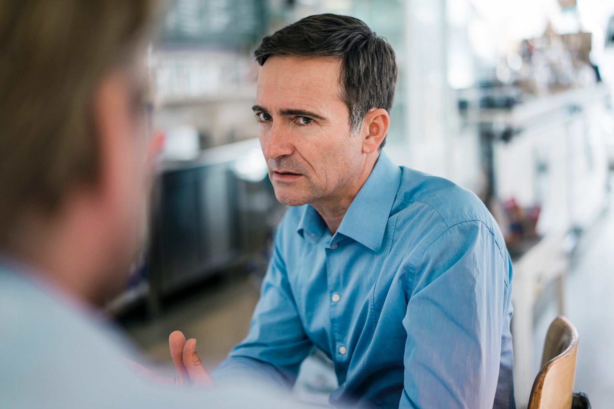 Portrait of serious businessman looking at colleague