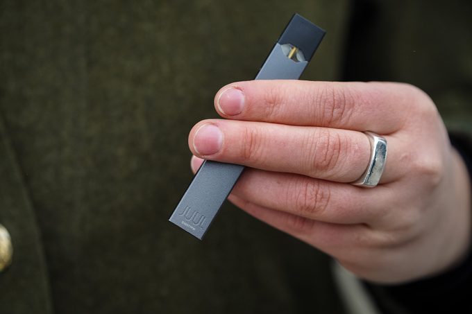 Woman holding Juul e-cig