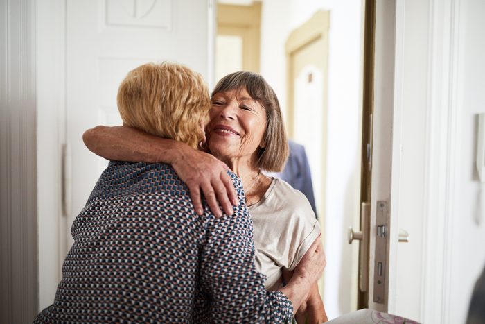 Senior couple visiting friends in their home