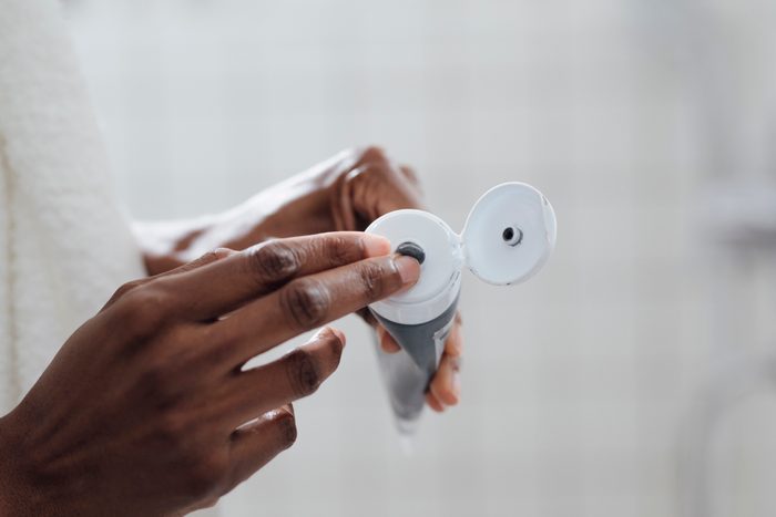 Woman Using Charcoal Cosmetic Face Mask