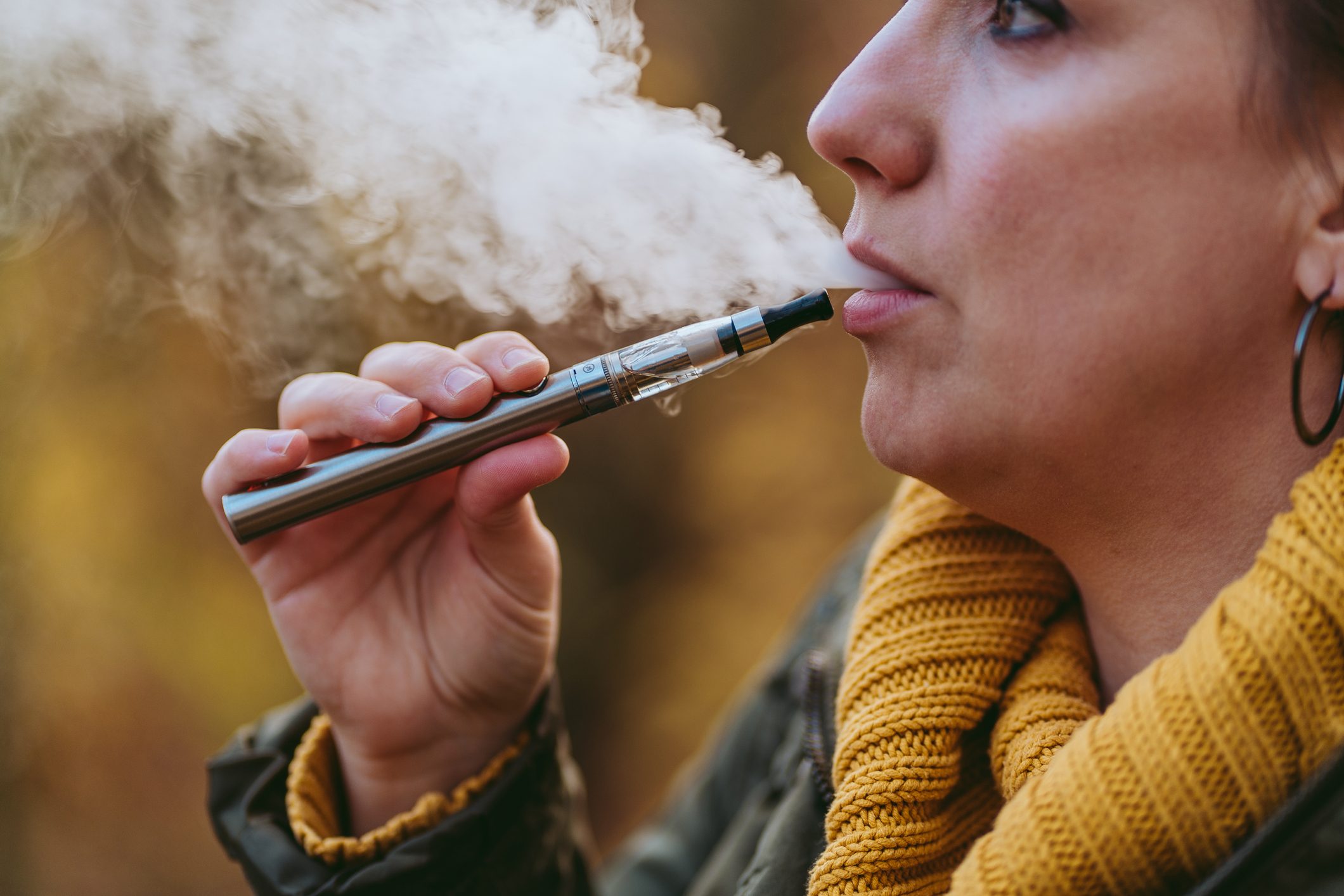 Close-Up Of Woman Smoking Electronic Cigarette