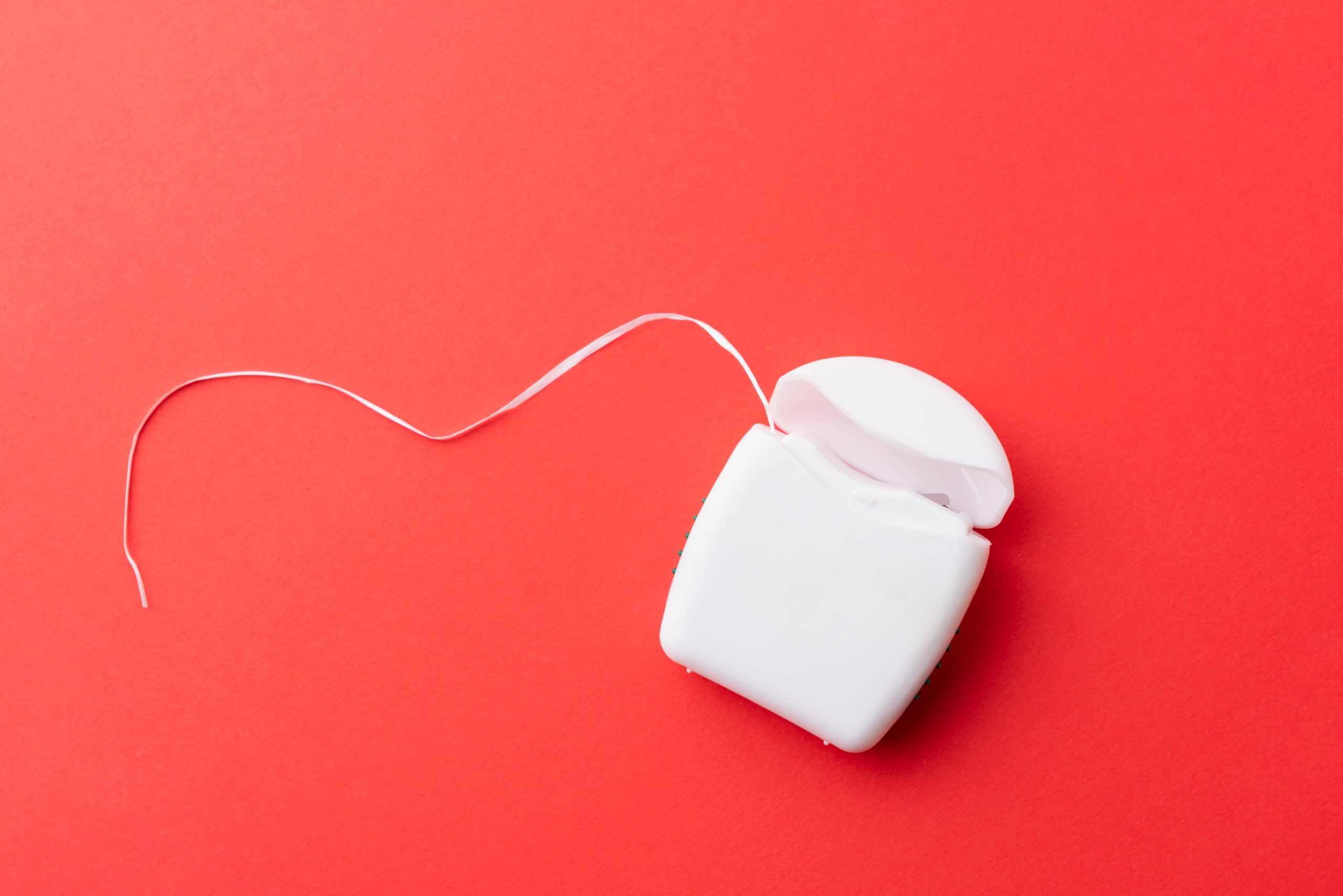 dental floss on red background