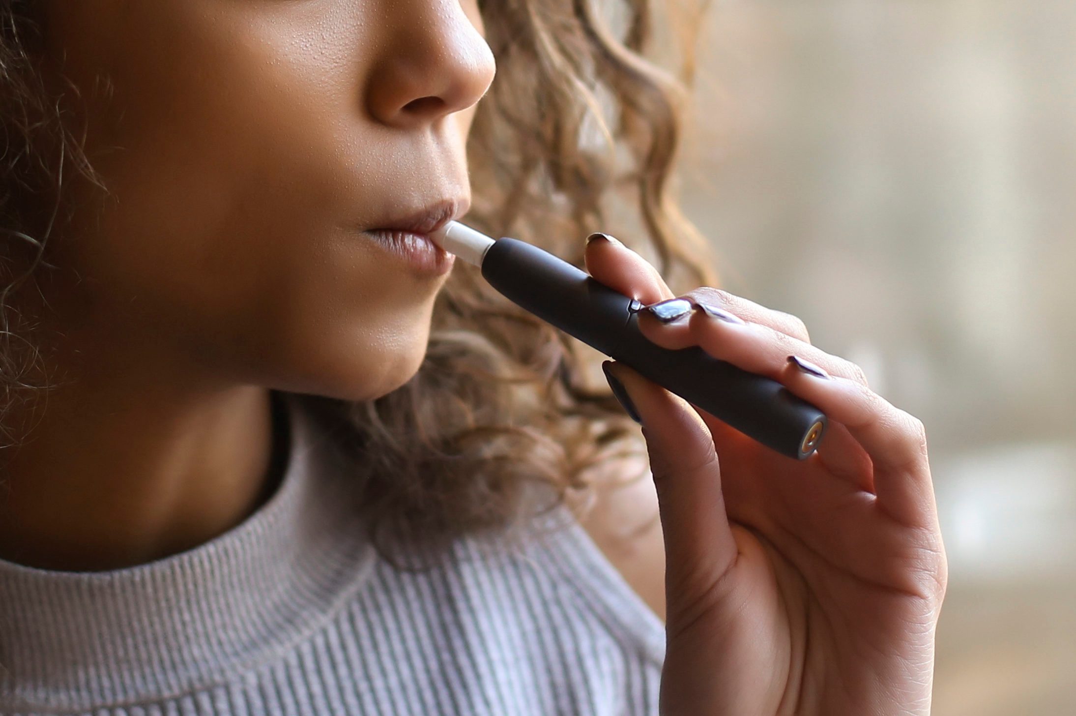 close up of young woman Vaping