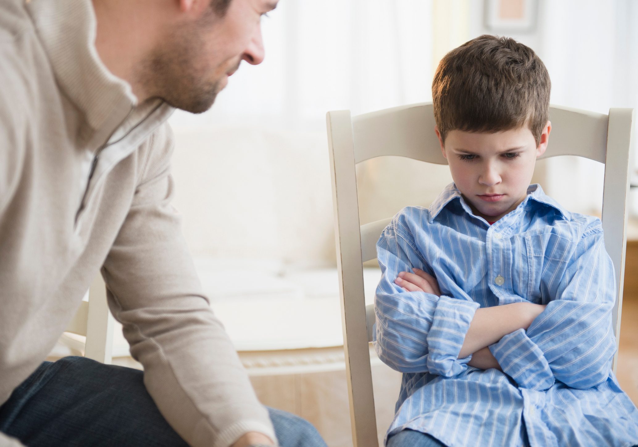 USA, New Jersey, Jersey City, Father looking at displeased son (8-9)