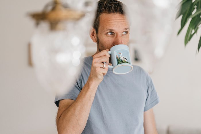 Man drinking coffee at home