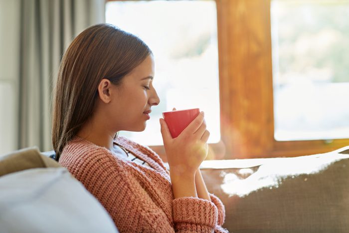 woman holding warm beverage