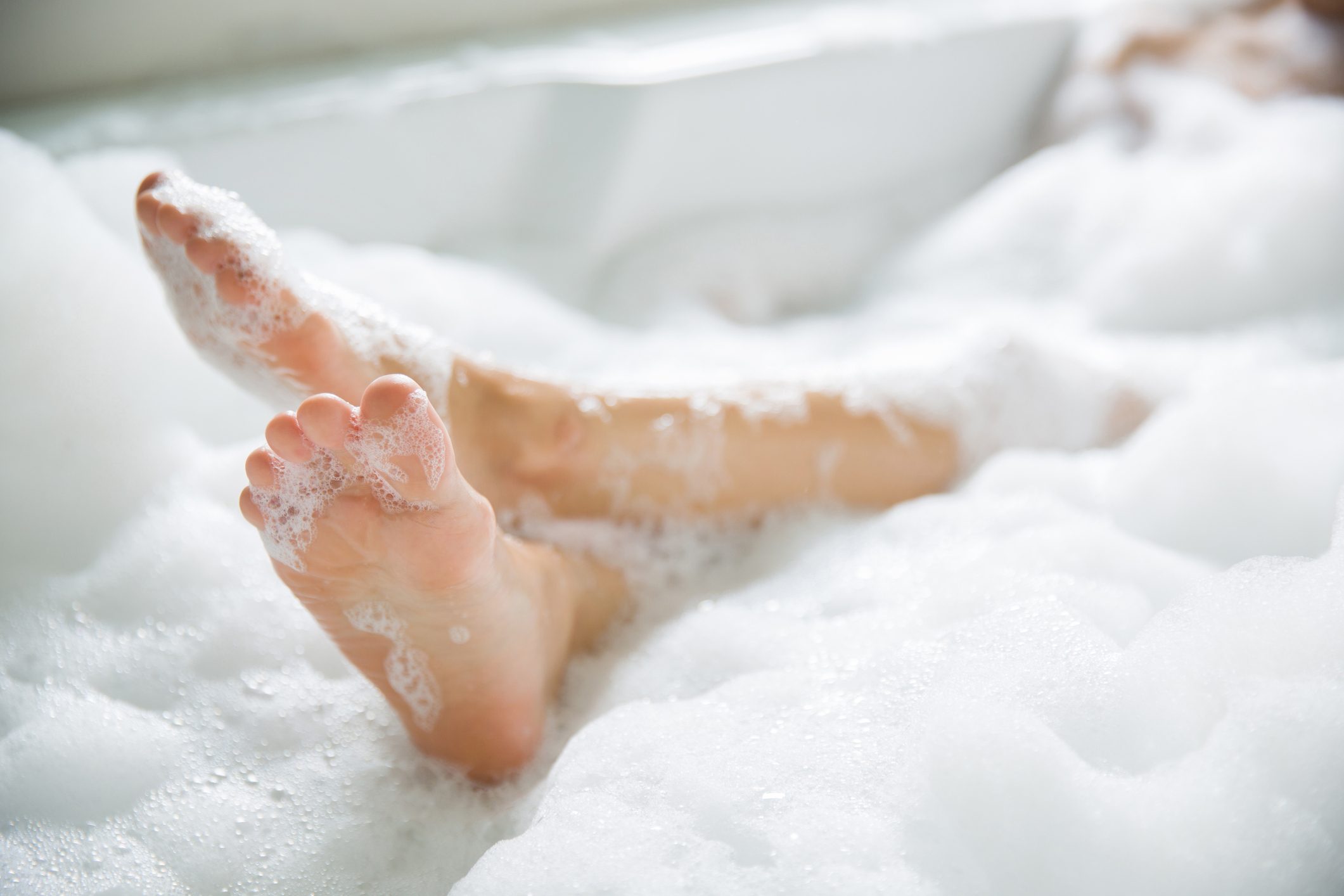 Close Up Of Feet In Bathtub