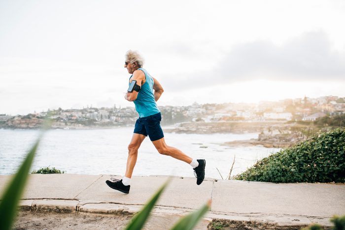 Senior man warms up for run