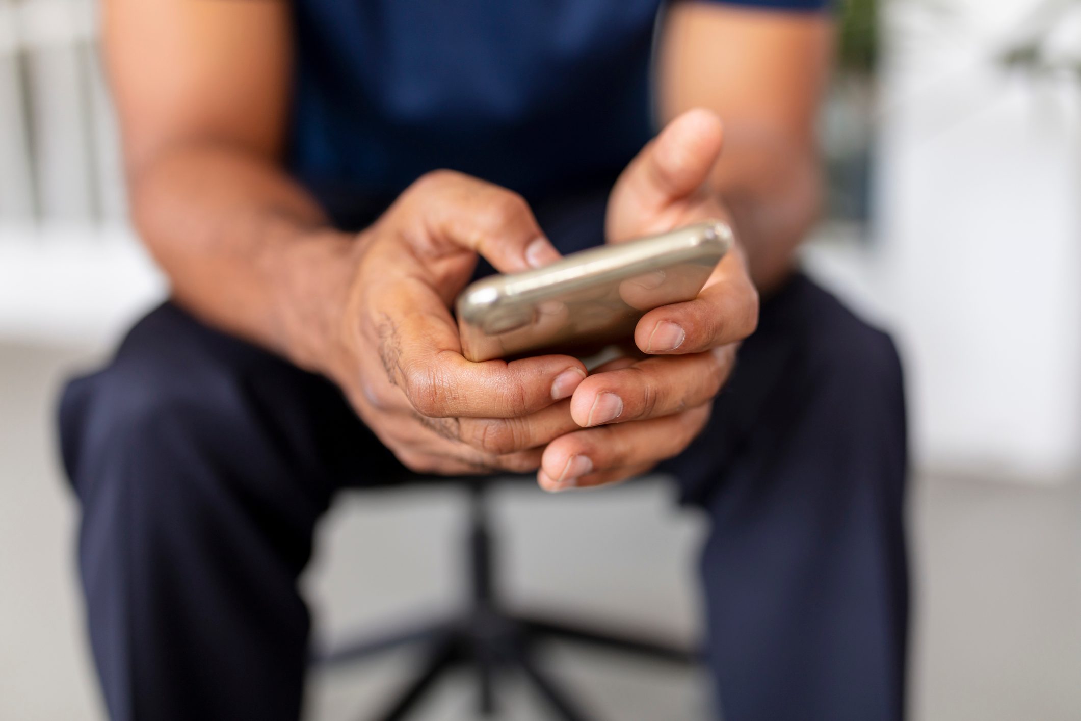 man using smartphone at home - close up