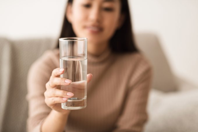 Girl Holding Mineral Water In Glass