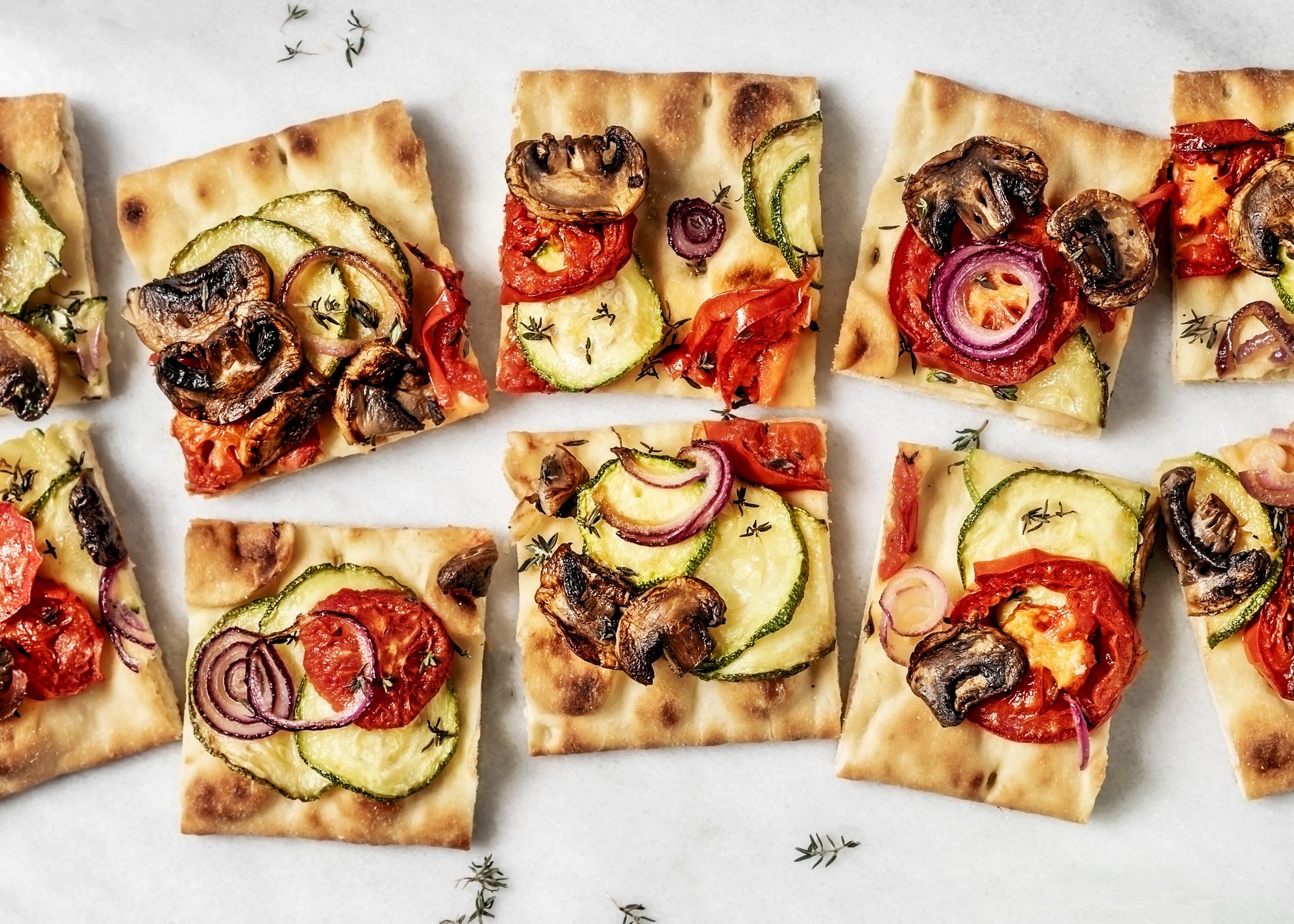 Vegetarian flatbread pizza on white background