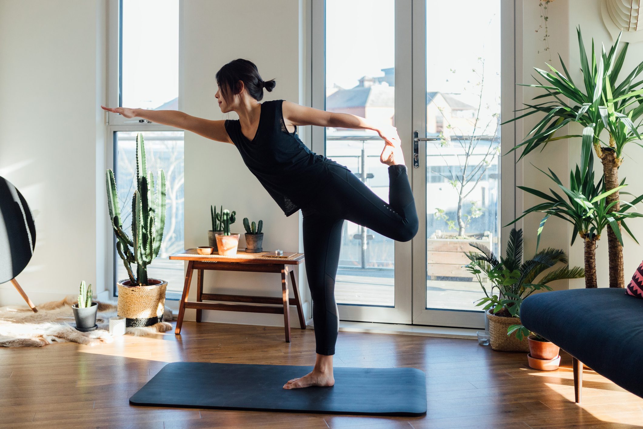 Young woman doing yoga exercise at home