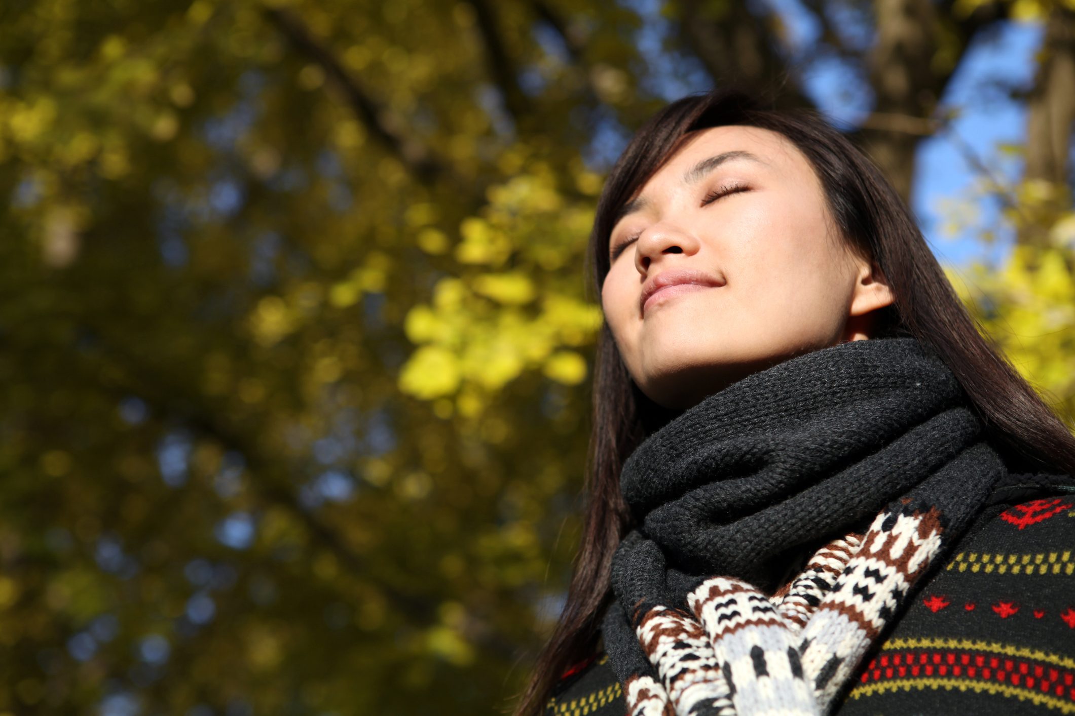 woman outside with eyes closed