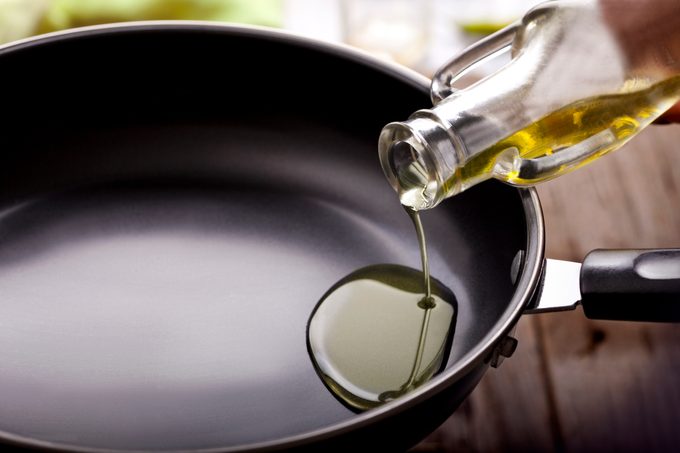 Pouring cooking oil in frying pan