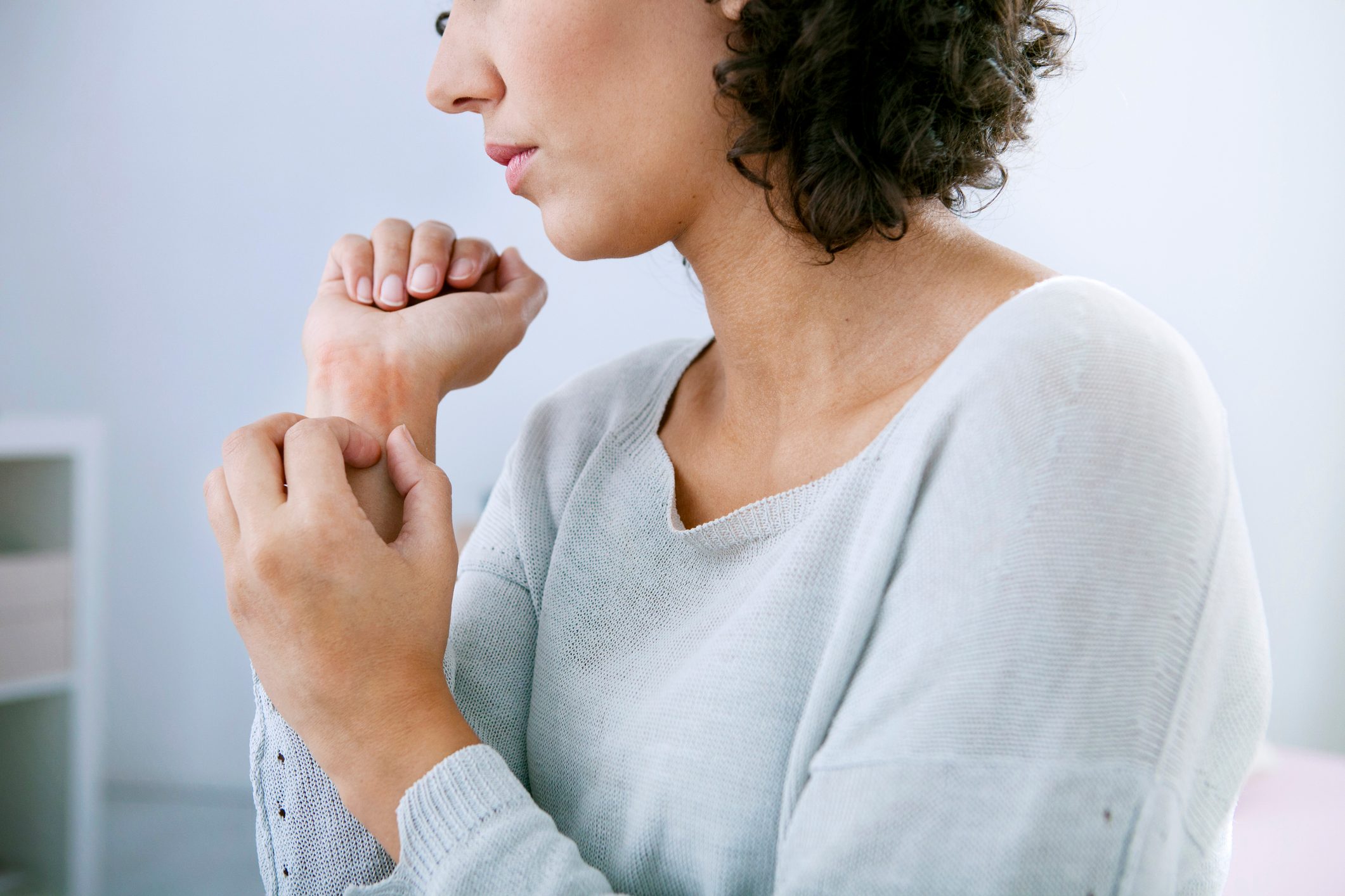 woman scratching her wrist