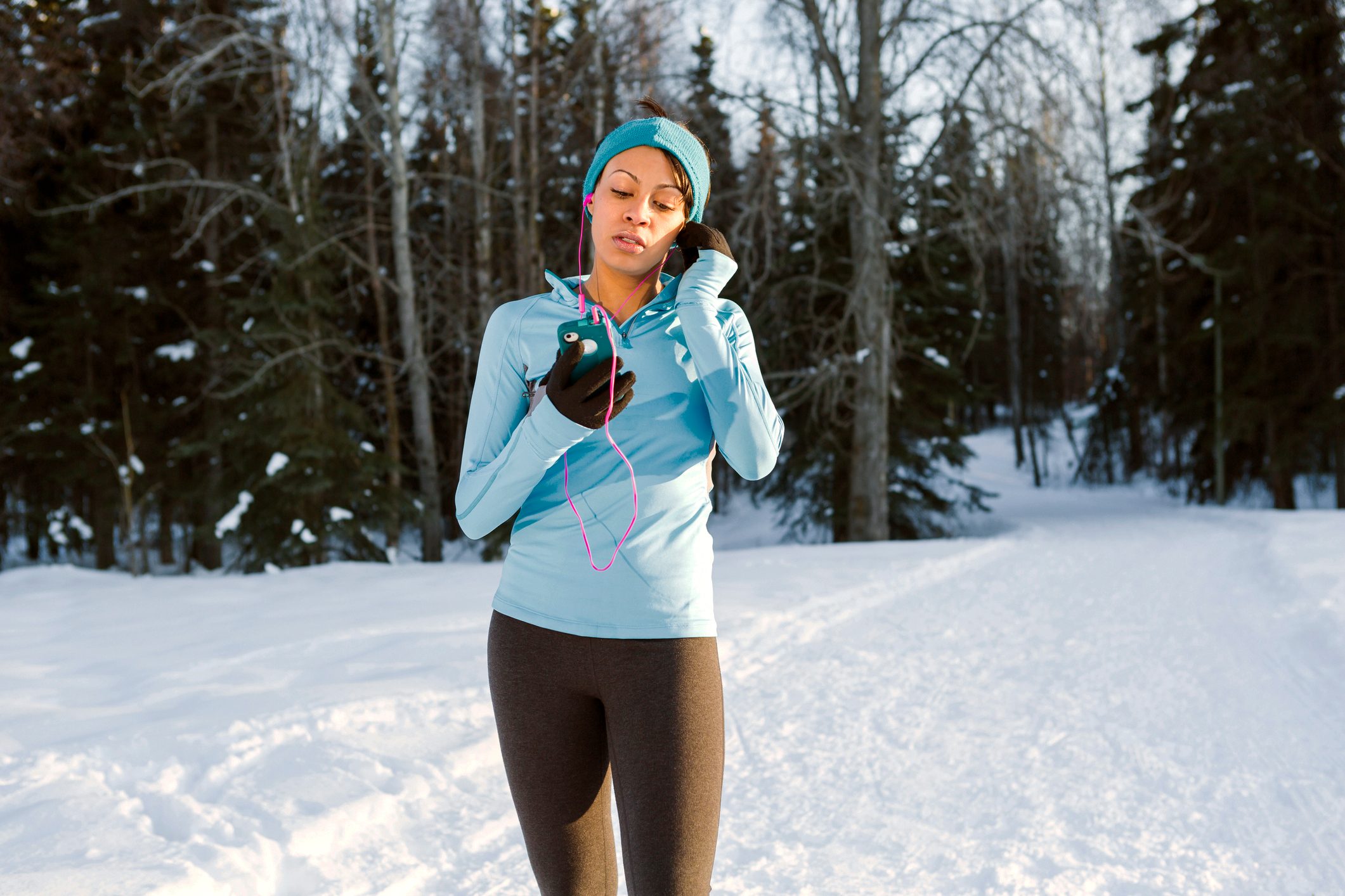 young woman going for exercise walk during the winter