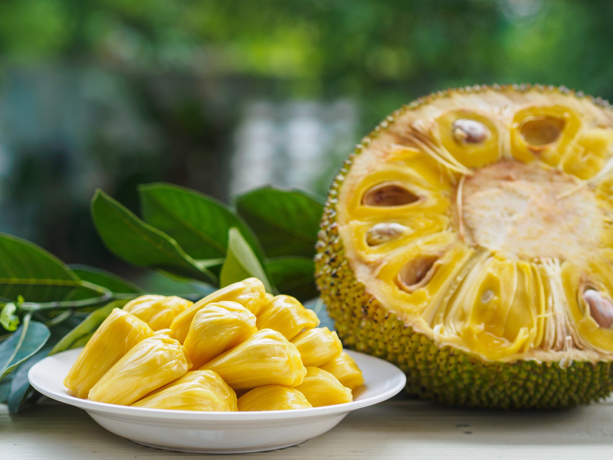 Fresh Jackfruit in white dish, half of jackfruit and jackfruit leaf