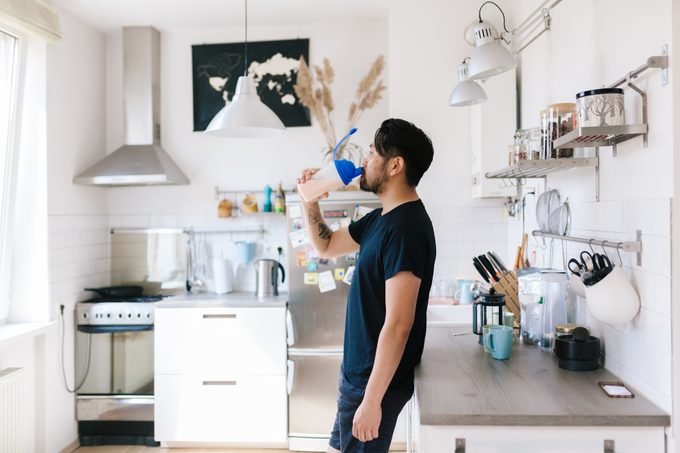 fitness vlogger drinks protein shake after home workout