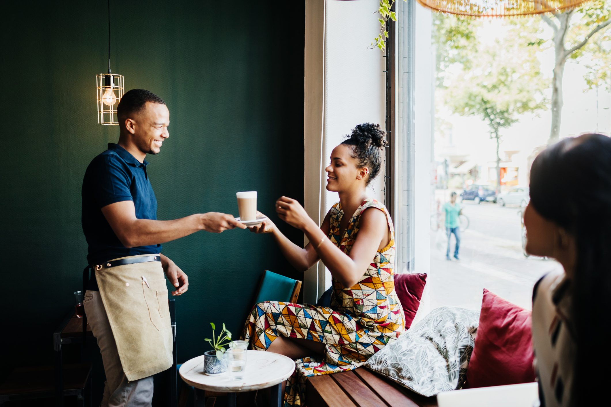 Barista Serving Customer Coffee