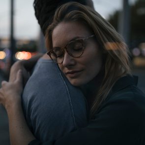 Young couple hugging in the city at dusk