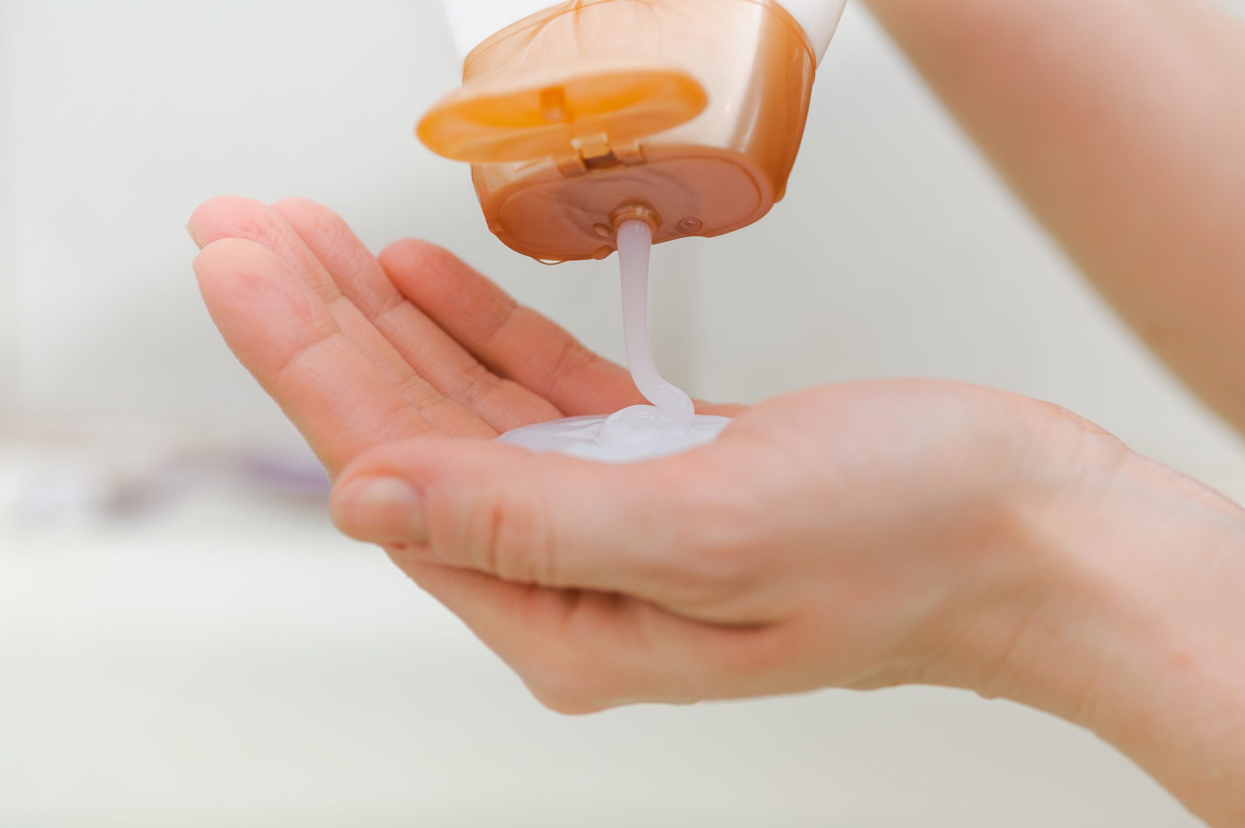 closeup of shampoo pouring into hand