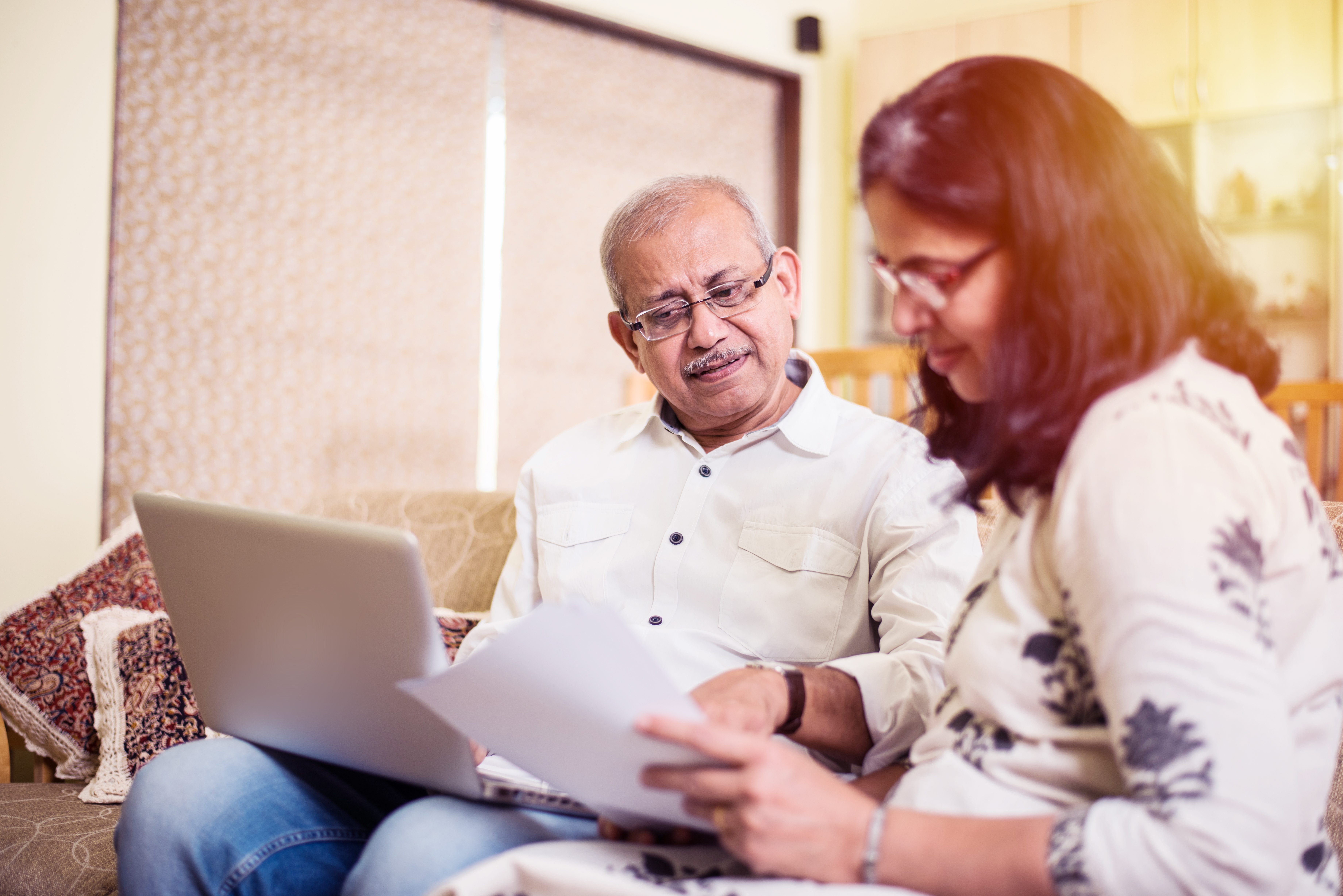 Senior couple reading paperwork together