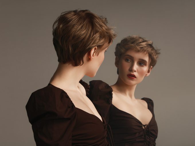 Young woman and her mirror reflection