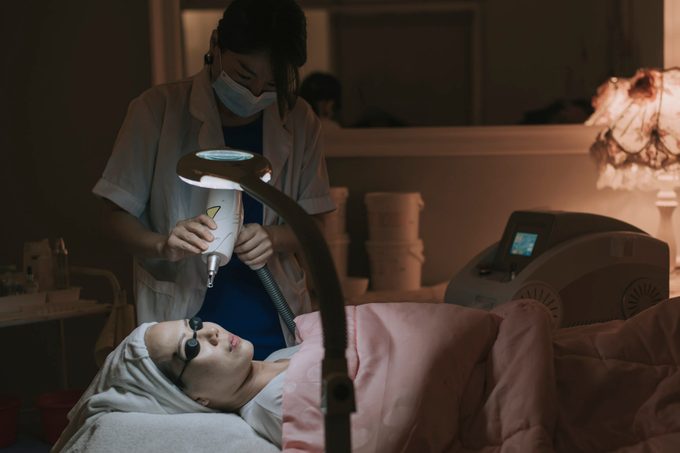 Laser pulses clean skin of the face. Hardware cosmetology treatment. Process of photosynthesis, warming the skin, laser carbon Facial skin rejuvenation