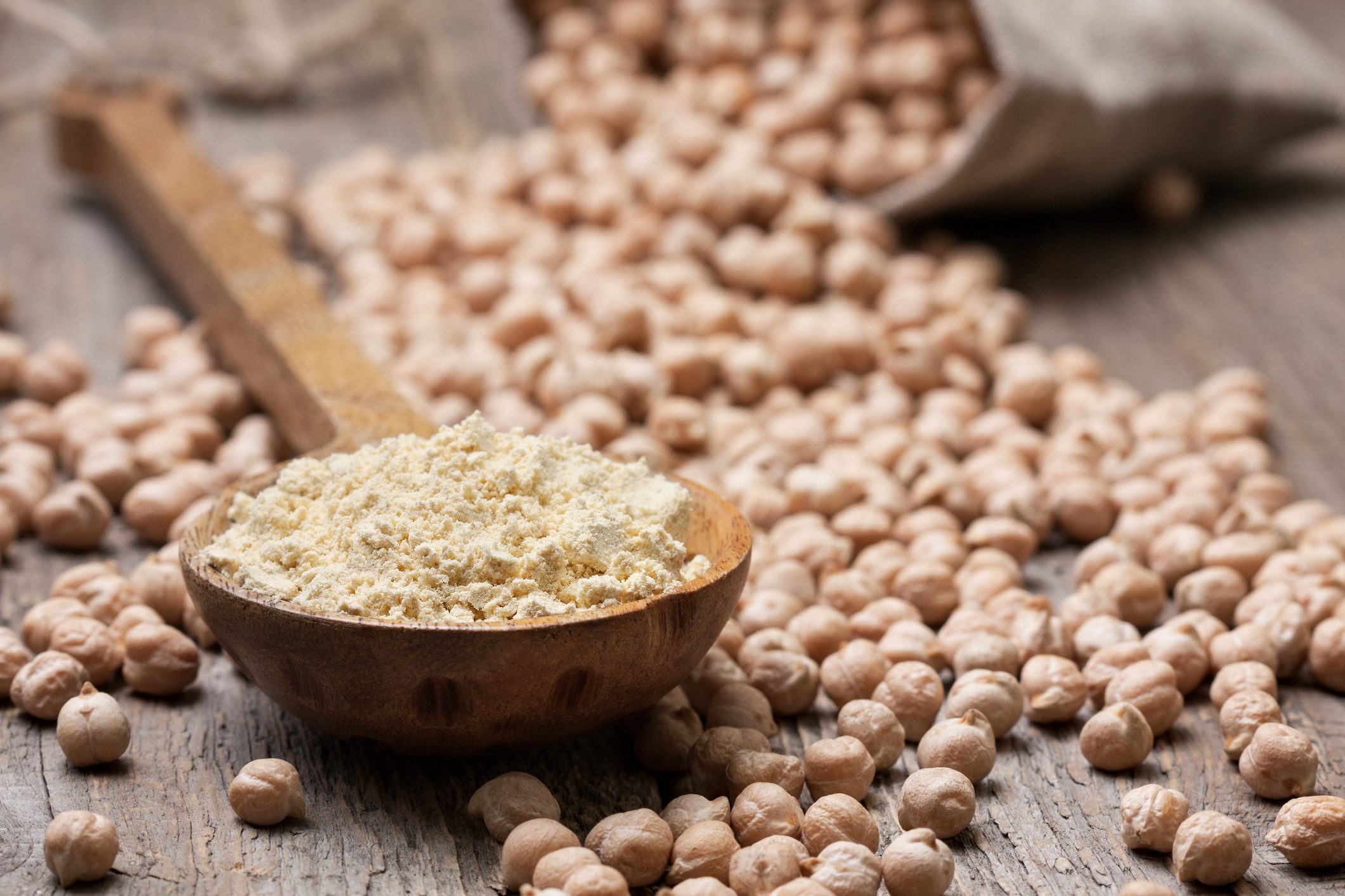 Chickpea flour in a wooden spoon