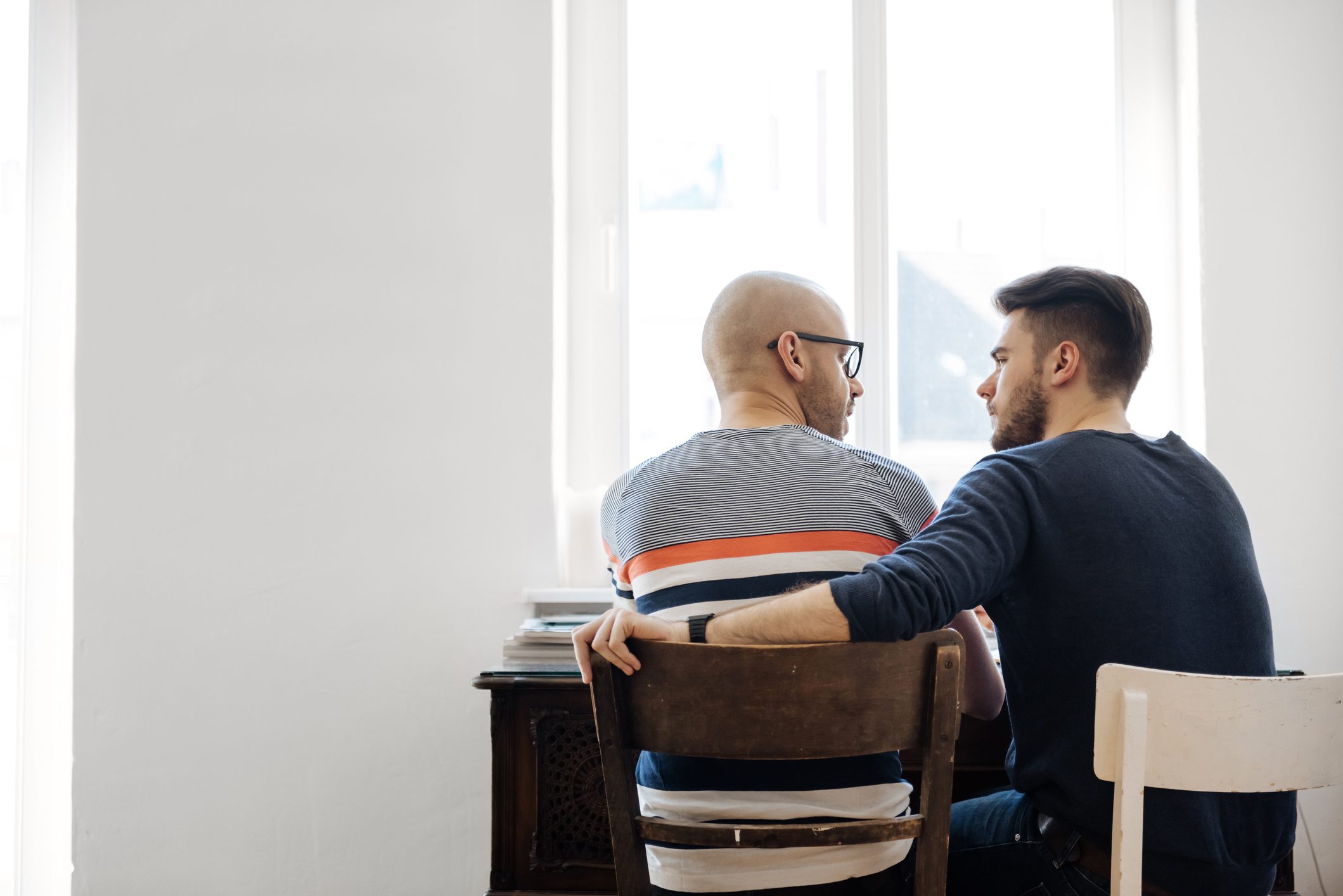 Back Shot Of Gay Couple Sitting Together