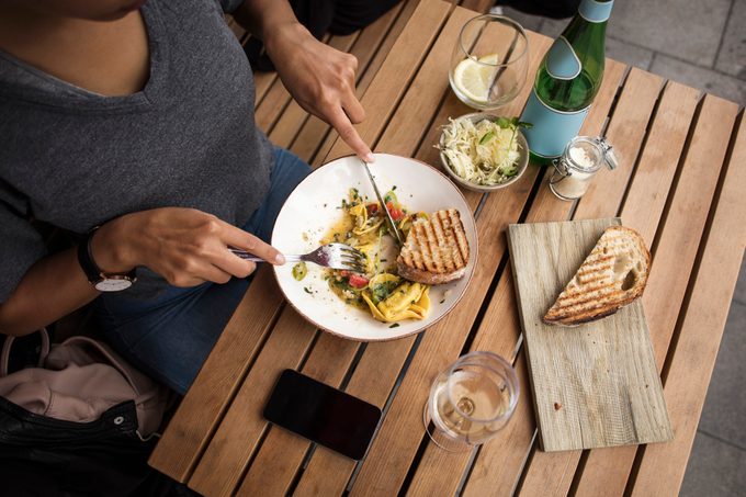 High angle view of woman having lunch at sidewalk cafe table
