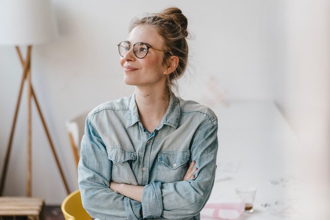 Smiling young woman in office looking sideways