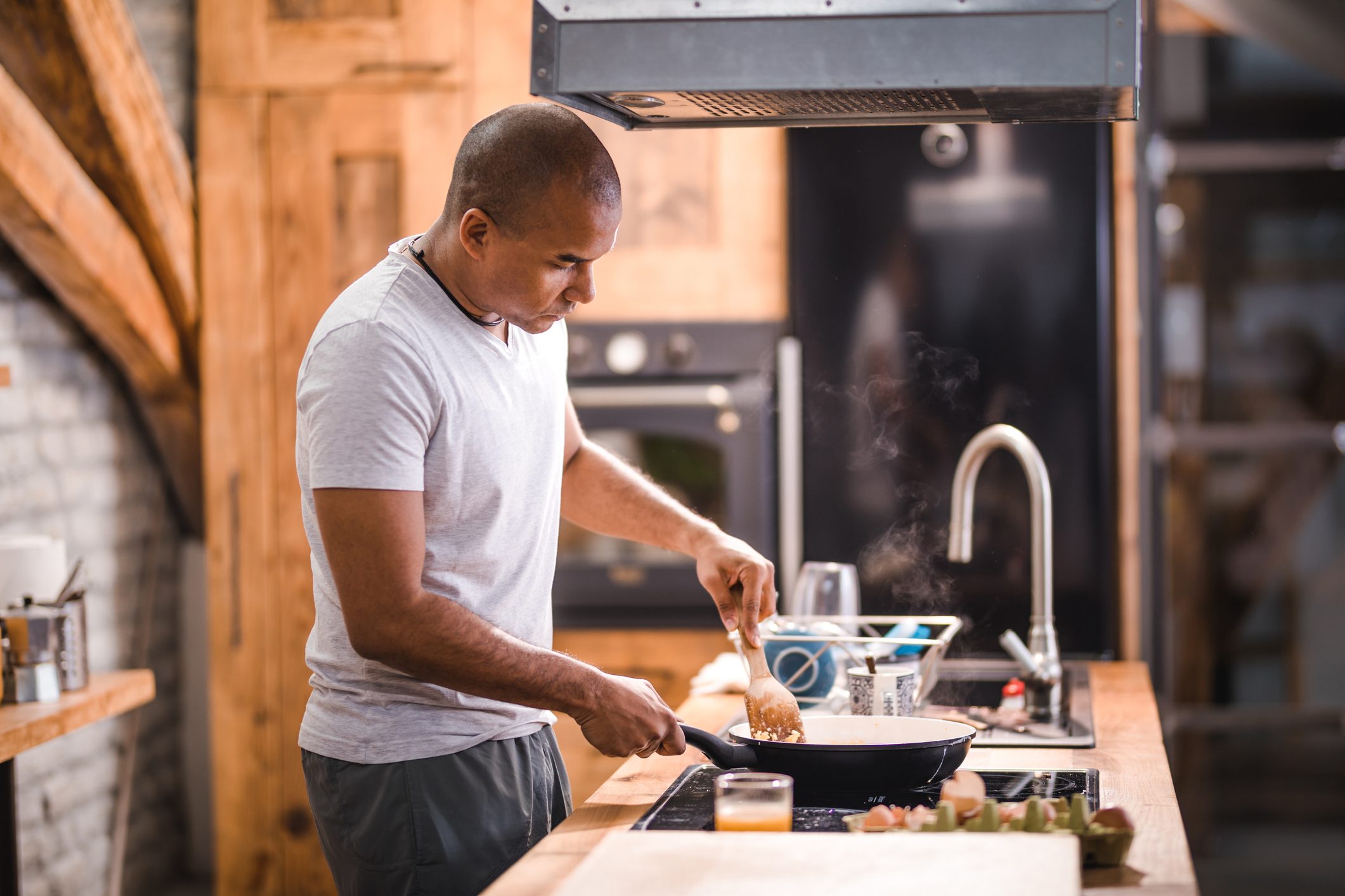 man preparing scrambled eggs for breakfast.