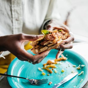 Woman Eating Tasty Vegan Burger