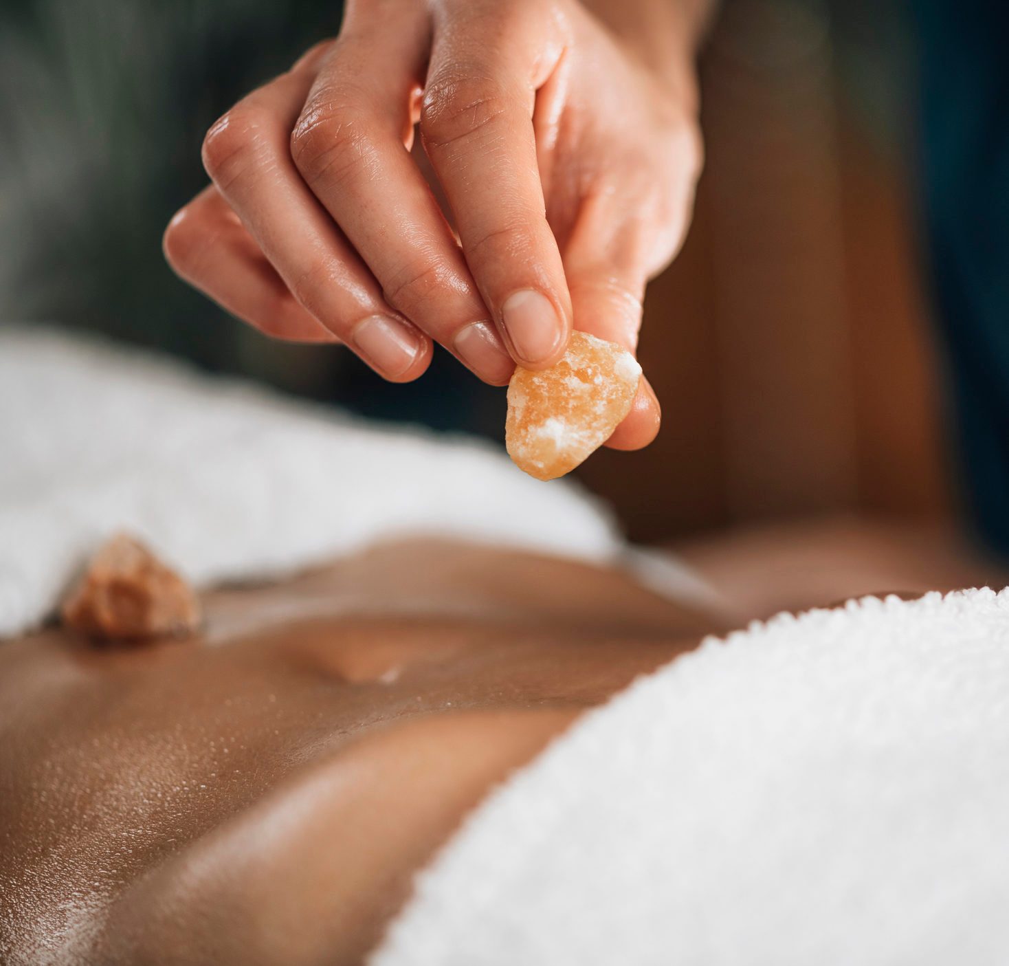 Ayurvedic Practitioner Using Gemstones And Crystals For Healing Female Patient Chakras